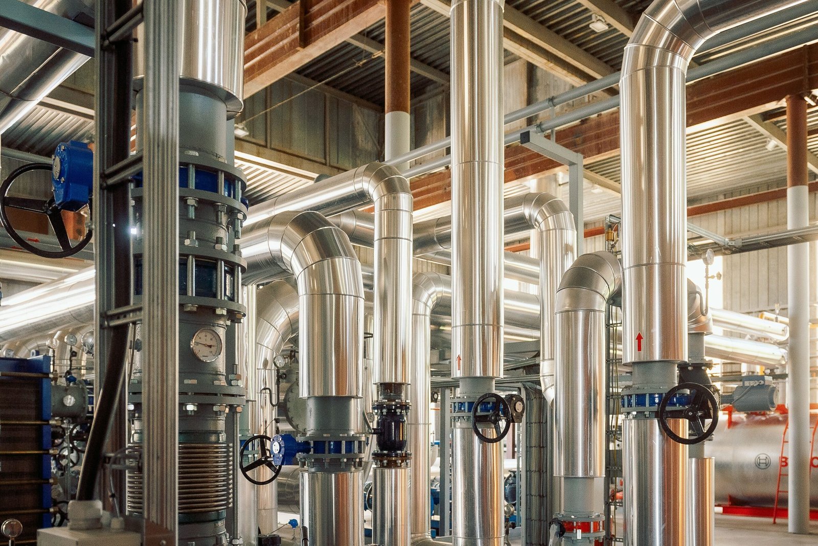 Industrial-grade stainless steel piping system for steam and fluid transfer in manufacturing plant