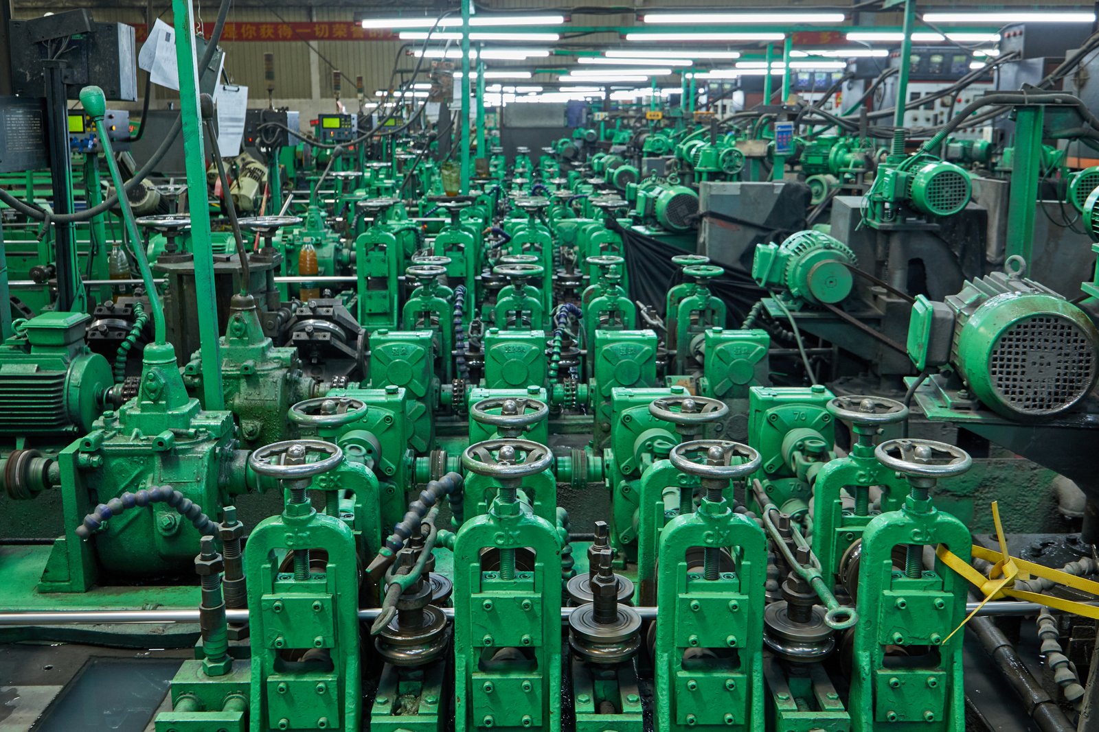 Close-up of stainless steel pipe straightening rollers during high-precision forming at MFY