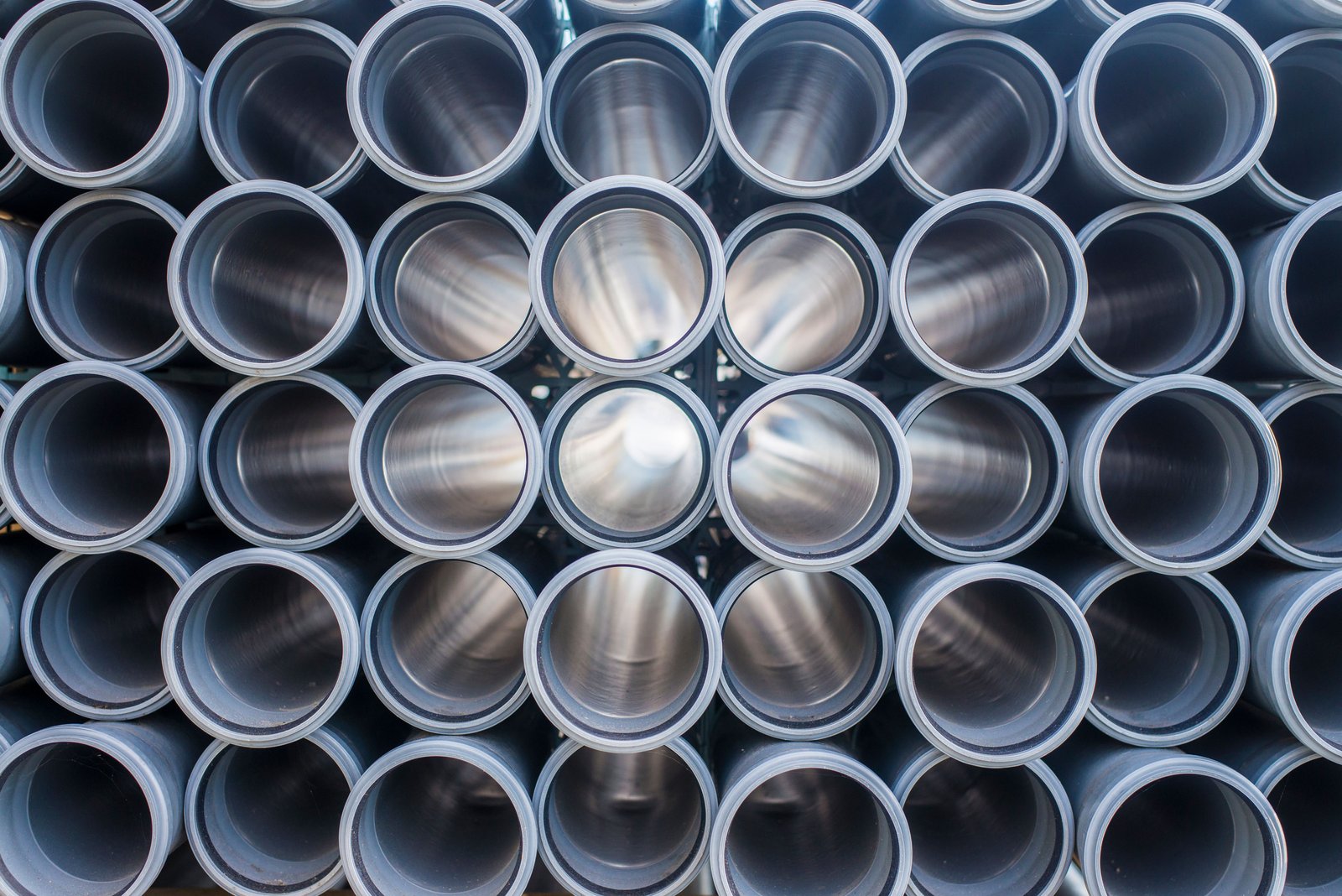 Large-diameter stainless steel pipes stored outdoors for municipal or industrial pipeline installation