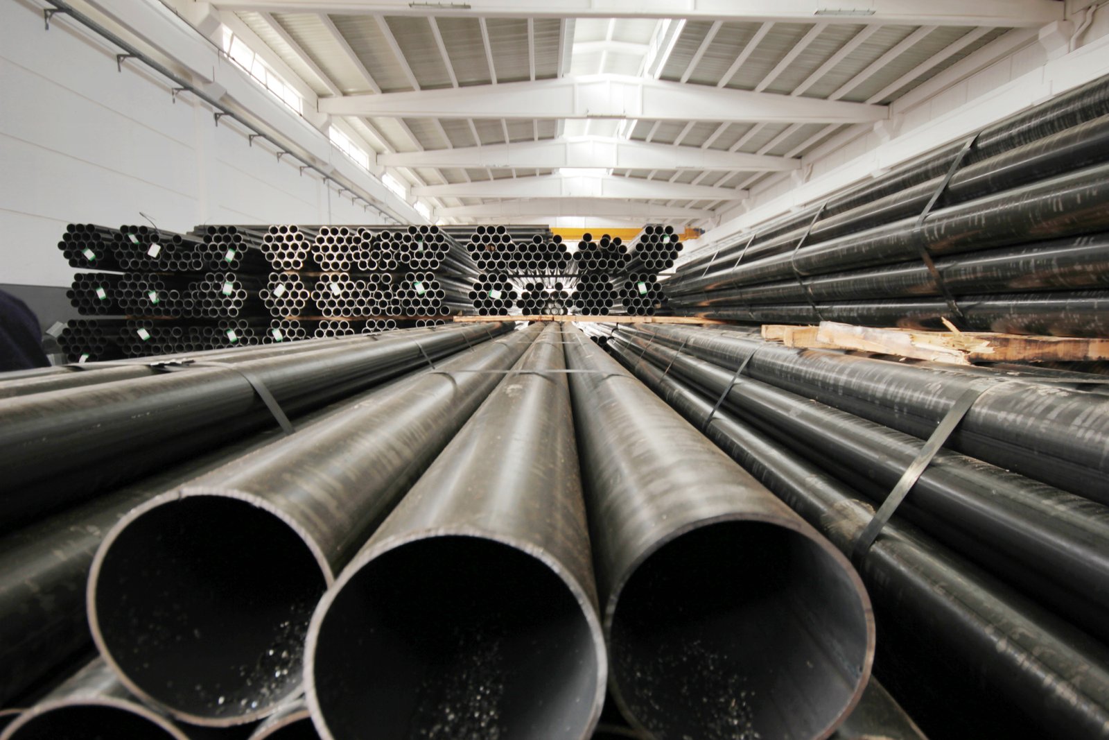 Warehouse inventory of black finish stainless steel pipes ready for export and logistics