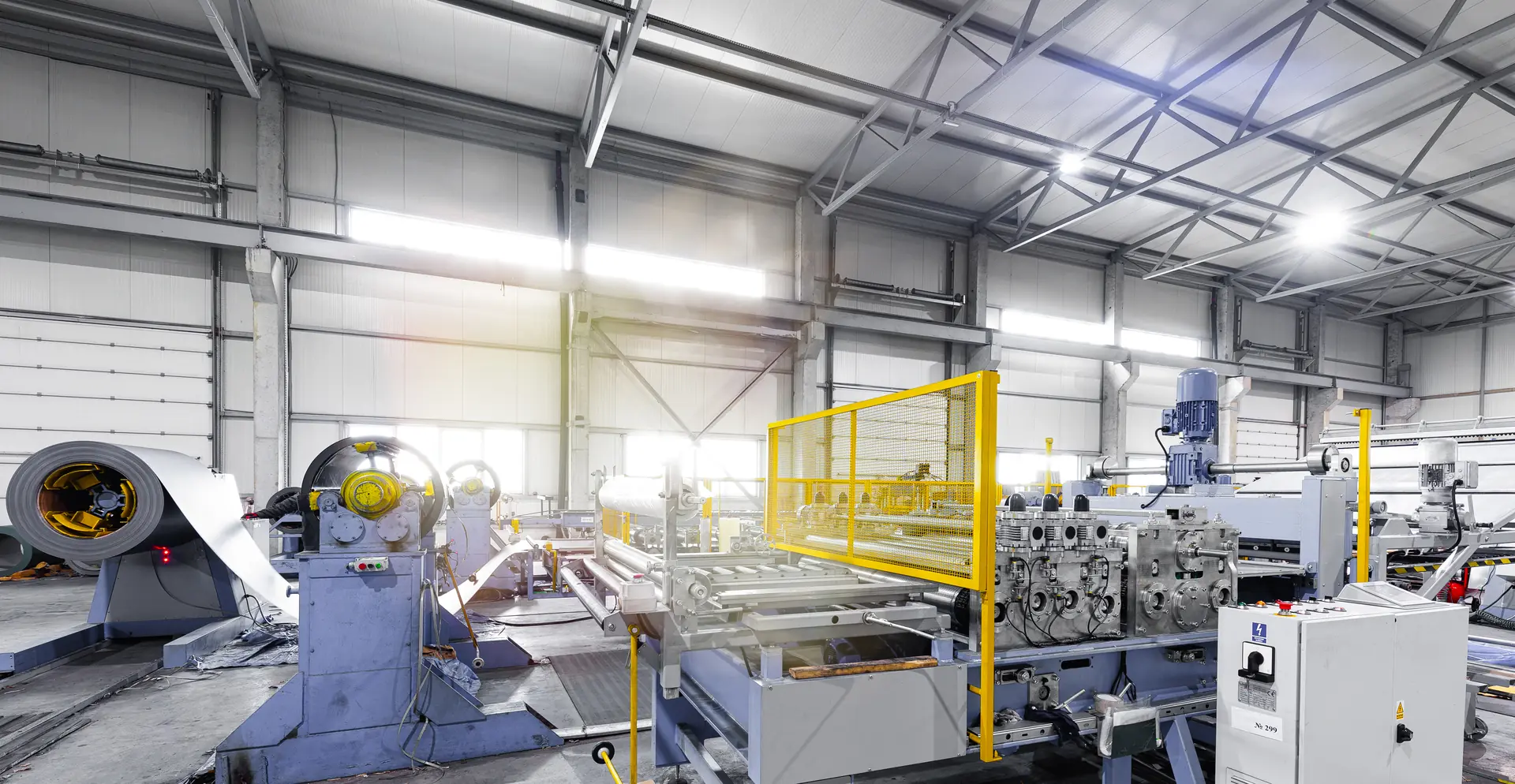 Modern stainless steel processing machinery in a well-lit factory